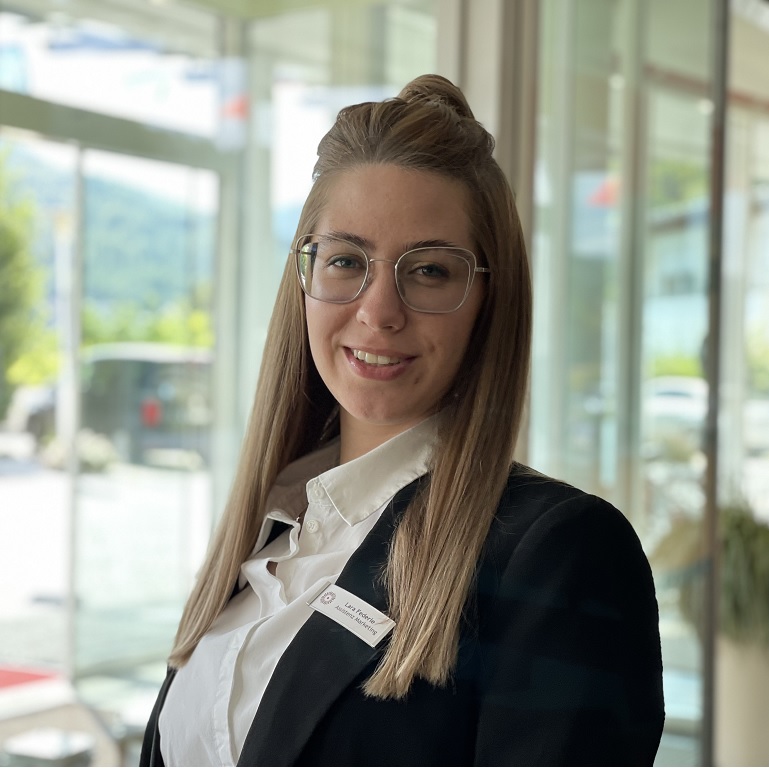 Mrs. Federle in front of an lighted window, she is marketing assistant in the Hotel Schwarzwald Panorama